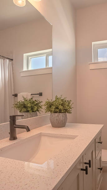 istock Vertical frame Toilet and vanity with cabinets and sink undermounted on the white countertop 1166268095