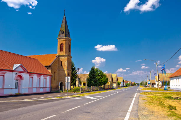 Street view of Karanac church and historic architecture Street view of Karanac church and historic architecture, ethno village in Baranja region of Croatia osijek photos stock pictures, royalty-free photos & images