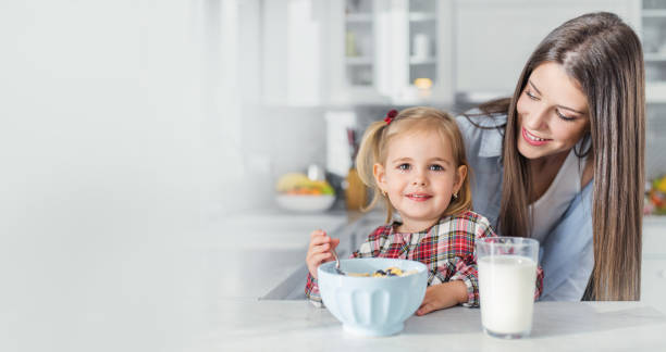 istock Mother and daughter preparing breakfast. Copy space. 1166269815