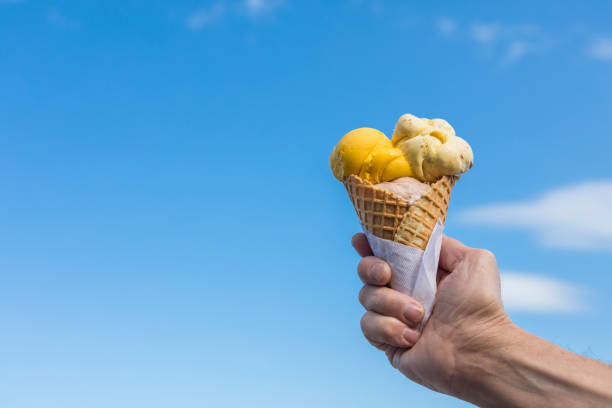 istock Ice cream waffle cone with a blue sky background. 1166269996