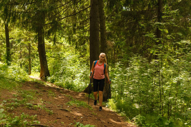 istock young woman trekking in a mountain forest 1166270077