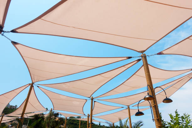 Sun shade sails Sun shade sails with sky background. shade stock pictures, royalty-free photos & images