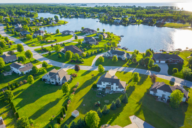 Beautiful Waterfront Homes On Lake At Sunrise In Summertime. Beautiful Waterfront Homes On Lake At Sunrise In Summertime. land of lakes stock pictures, royalty-free photos & images