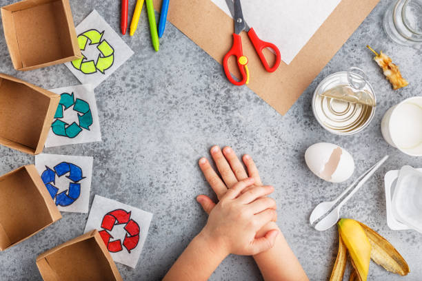 Girl hands are making recycling game in paper on grey background colourful Child hands. Recycle eco symbol. Paper craft. Ecology, waste recycling concept. crayon drawing photos stock pictures, royalty-free photos & images
