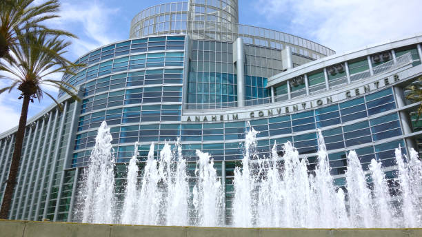 Wide shot of the Anaheim Convention Center A wide shot of the Anaheim Convention Center with the main fountain and palm trees on a sunny day. anaheim california stock pictures, royalty-free photos & images