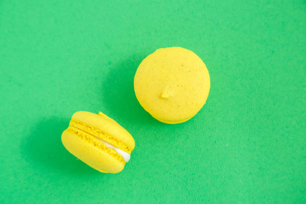 istock colorful macarons or macaroons cookies on green background. top view 1166272705