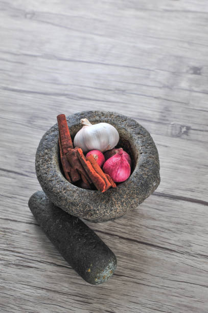 istock Mortar, star anise, cinnamon  on a wooden background 1166273458