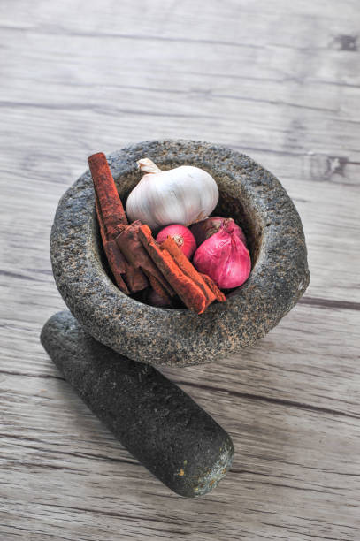 istock Mortar, star anise, cinnamon  on a wooden background 1166273467
