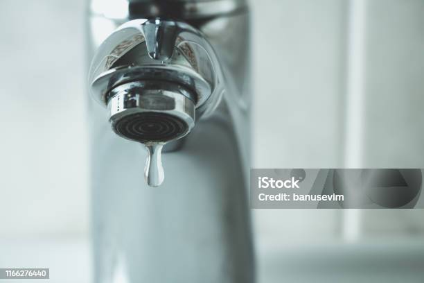 Water Drop Dripping From The Tap Stock Photo - Download Image Now - Faucet, Water, Water Conservation