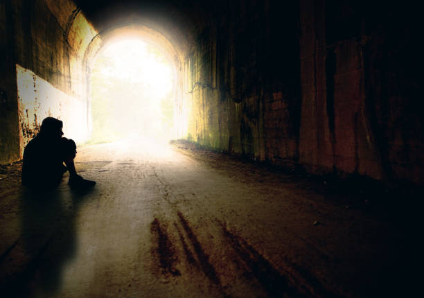 Lost and Alone The silhouette of a teenage boy lost and alone in a tunnel. silhouette of bad boy stock pictures, royalty-free photos & images