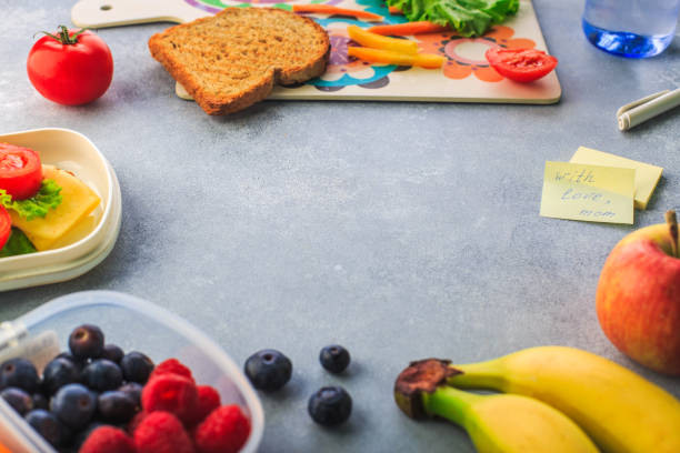 istock Lunchboxes with sandwiches and different products on grey background 1166277992