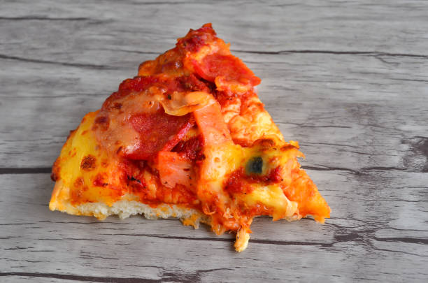 istock Cheese pizza on wooden  background 1166278180