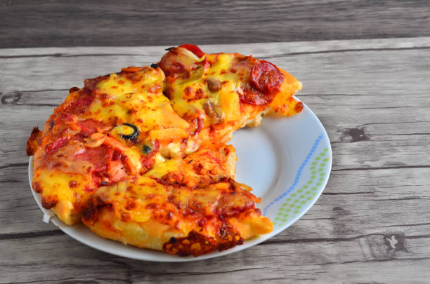 istock Cheese pizza on wooden  background 1166278182