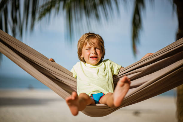 istock Cute boy swinging at the beach 1166279552
