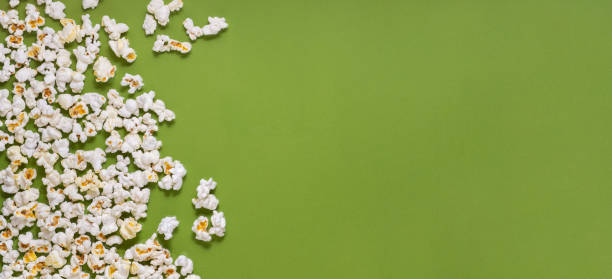 istock White tasty popcorn on a green background. Popcorn pattern on green background. Top view. Copyspace for your text. 1166279681