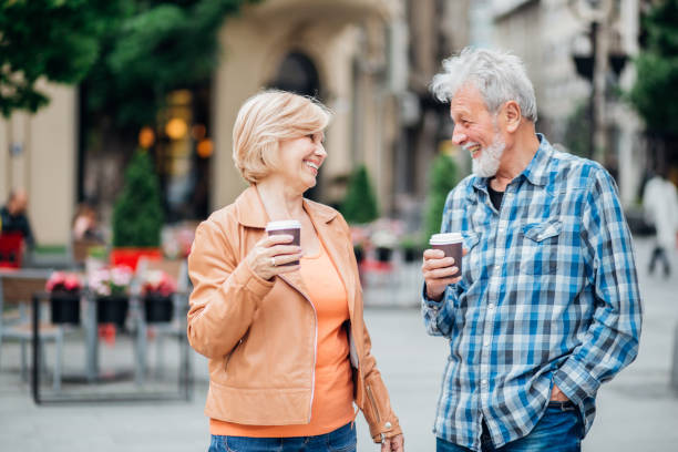 istock Mature couple drinking coffee and having fun outdoors 1166280883
