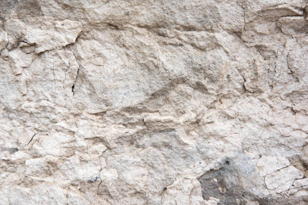istock The texture of a light stone wall that partially collapses. Background for the banner. The basis for design 1166281027