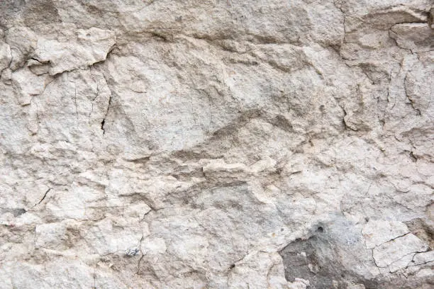 The texture of a light stone wall that partially collapses. Background for the banner