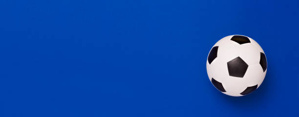 istock Soccer ball or football on blue background 1166281152