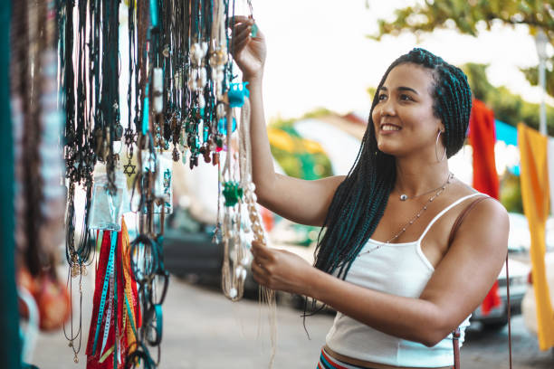 Black woman looking and choosing crafts at Olinda fair Braided Hair, Black Color, Women, Day, Crafts craft stock pictures, royalty-free photos & images