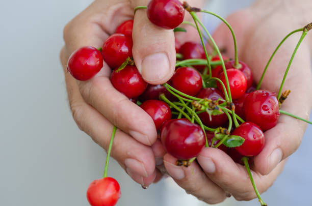 istock The man is showing the cherries 1166282405