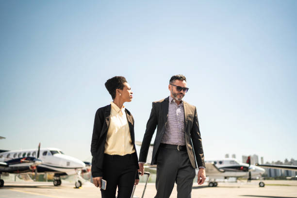 istock Colleagues walking in airport runway 1166283975
