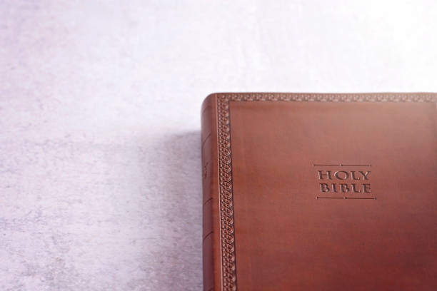 istock Brown Leather Holy Bible on a White and Gray Concrete Surface 1166284778
