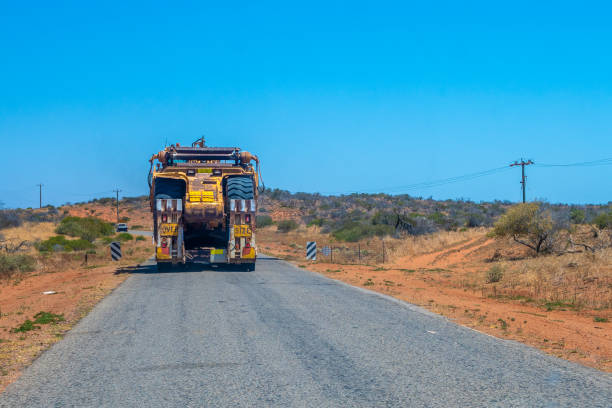 istock Road Train oversize transport in Australia transporting big mining equipment 1166285885