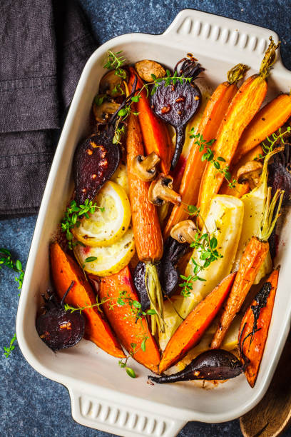 istock Baked vegetables with thyme in the oven dish, blue background. 1166286221
