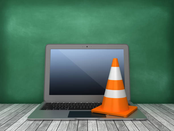istock Laptop with Traffic Cone on Chalkboard Background - 3D Rendering 1166288412