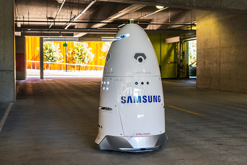August 1, 2019 San Jose / CA / USA - Knightscope security robot branded with the Samsung logo patrolling the parking lot of the Samsung Semiconductor offices, Silicon Valley