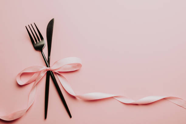istock Black setting: plates, inen napkin and silverware on pink background. Top view. 1166290155