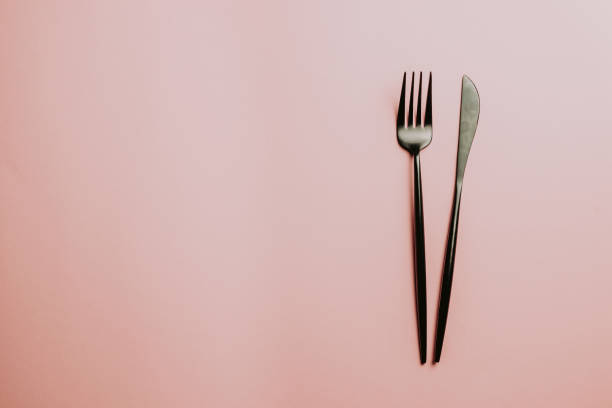 istock Black setting: plates, inen napkin and silverware on pink background. Top view. 1166290160