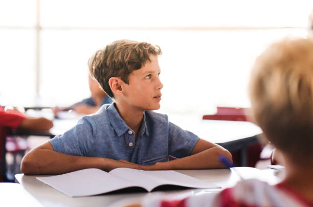 istock Boy listening while studying at desk in school 1166290508