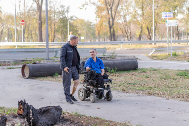 istock Two Men with Physical Disabilities in the Move are Having a Conversation on a Autumn Day Near in the Park 1166292207