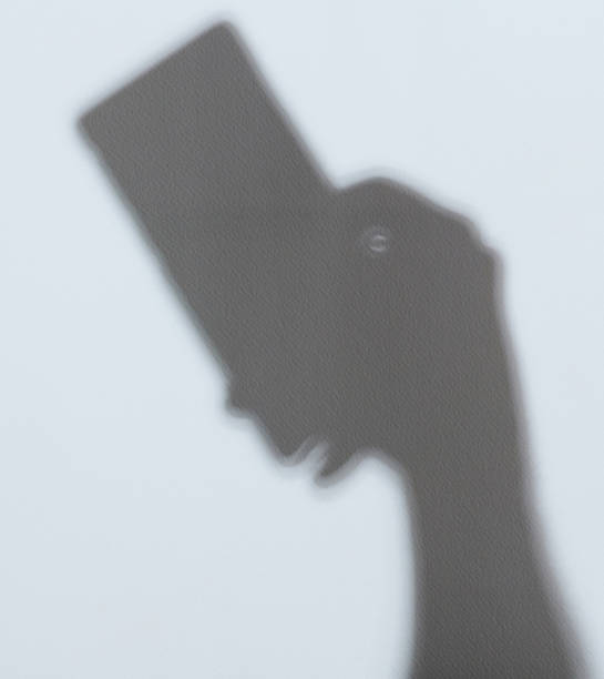 Shadow of smatphone in hand