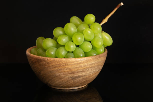 Fresh green grape isolated on black glass