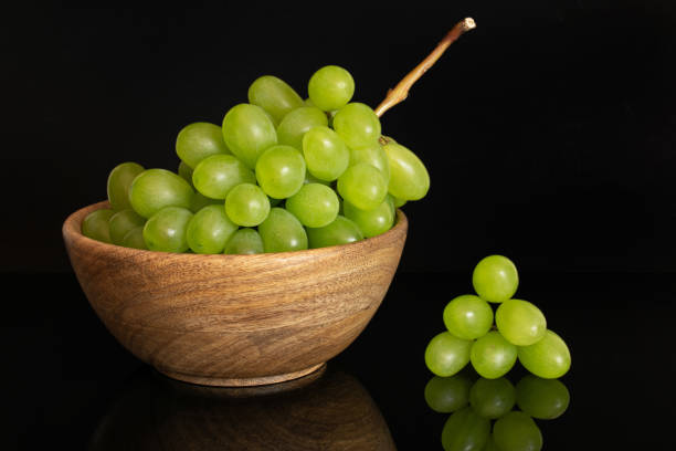 istock Fresh green grape isolated on black glass 1166293633