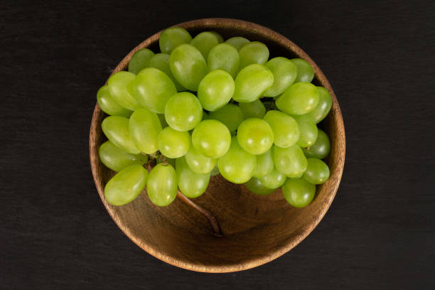 fresh green grape on grey stone - luminant imagens e fotografias de stock