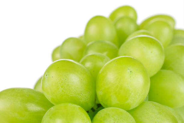 fresh green grape isolated on white - luminant imagens e fotografias de stock