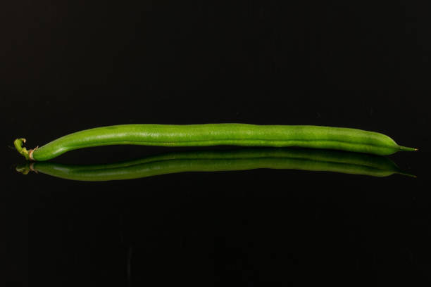 Fresh green bean isolated on black glass
