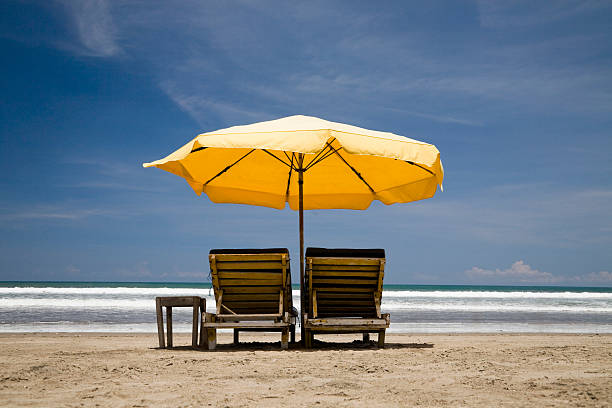 sun chairs with yellow umbrella