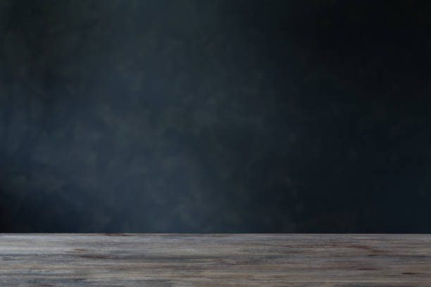 istock background with wooden table and dark wall 1166298537