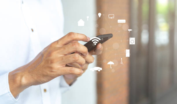 istock close up millennial man holding smartphone and turn on application for using home automation function to looking inside or outside home and property , ai innovation future technology  concept 1166298836