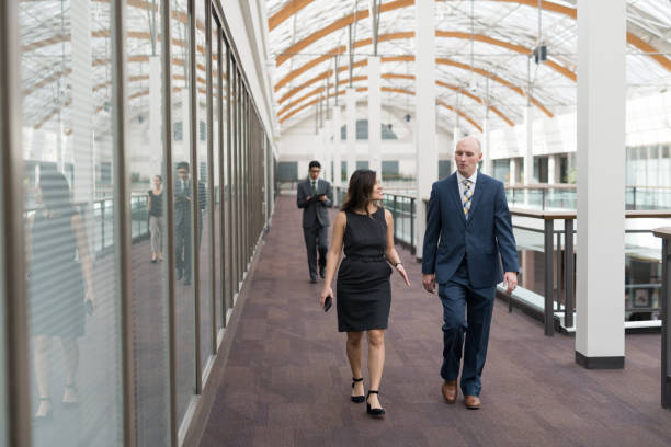 istock Two colleagues talking on their way to a meeting 1166299085