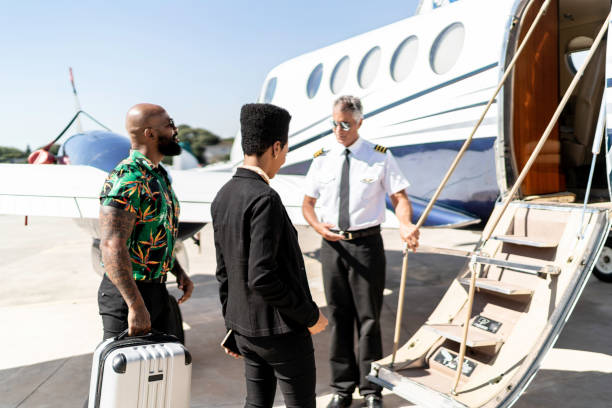 istock Colleagues boarding into flight in a corporate jet being welcomed by the pilot 1166299991