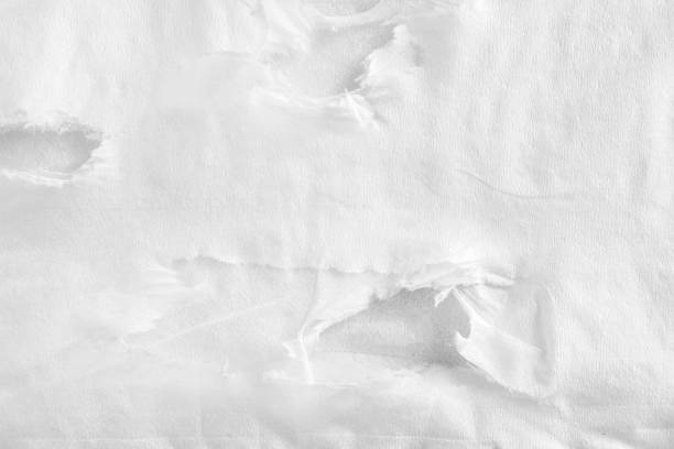 Closeup white torn crumpled sheet of thin napkin paper texture background. stock photo