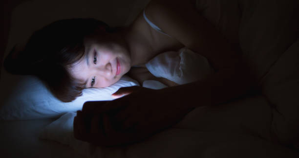 istock Woman Use Phone On The Bed at night 1166307131