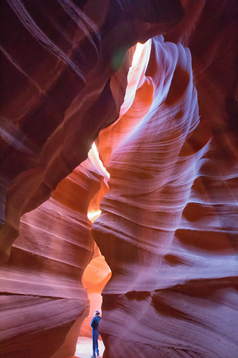 Page Arizona United States - April 7th, 2014 : A female tourist hiking and looking over the cracks at the Lower Antelope Slot Canyon, Page Arizona.