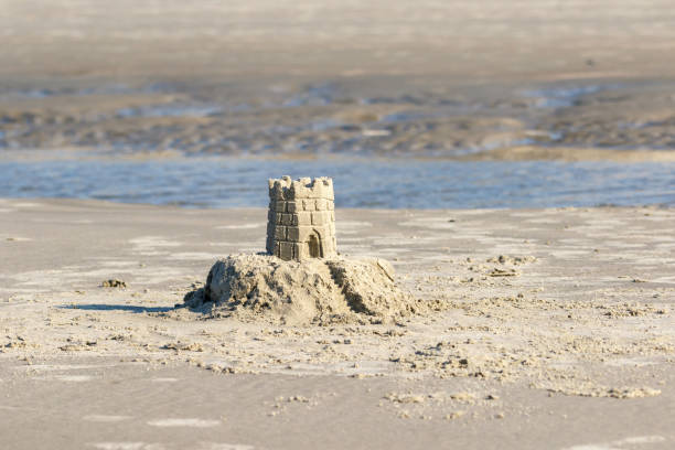 istock Beach sand castle on the sea shore 1166310185